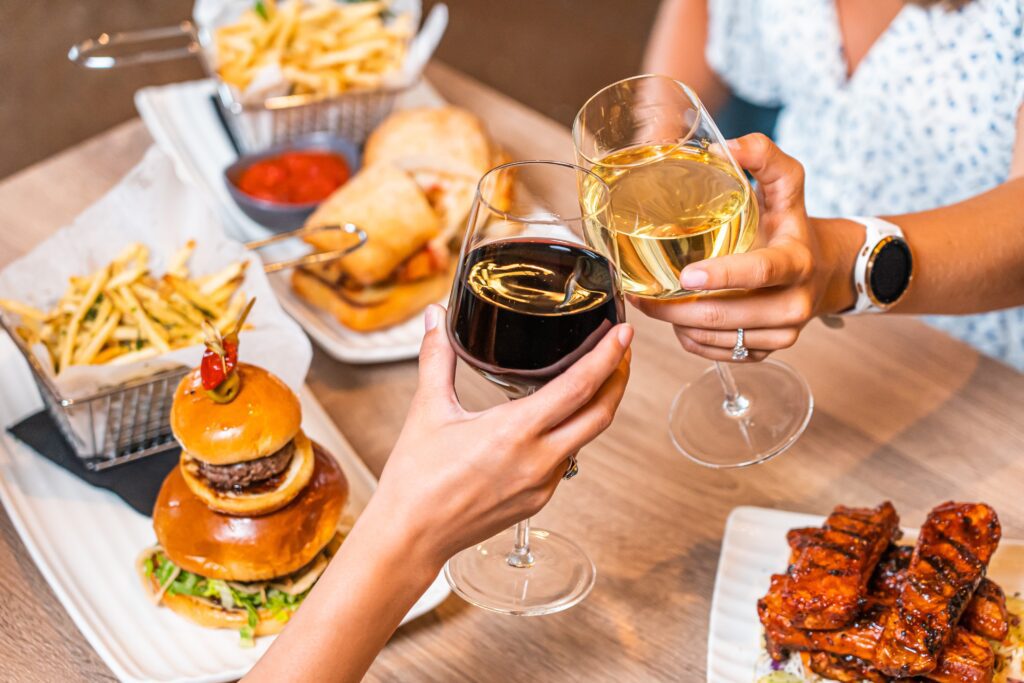 A group of people holding wine glasses at a table.