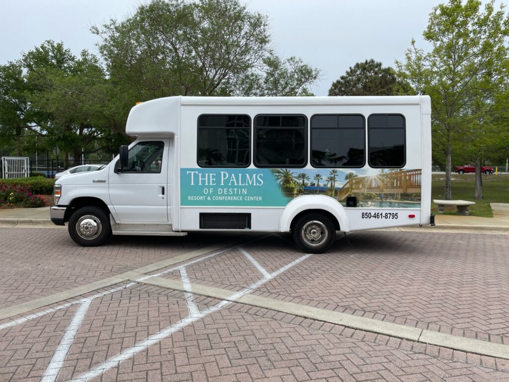 A white bus parked in the parking lot.