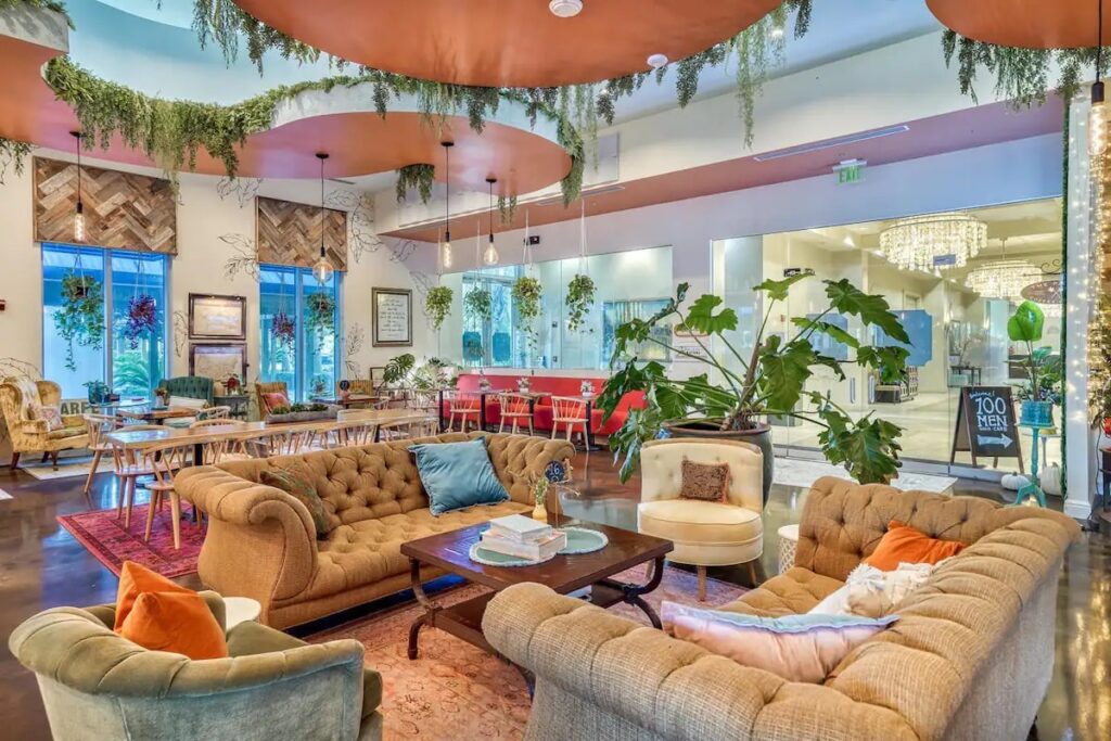 A living room filled with furniture and plants.